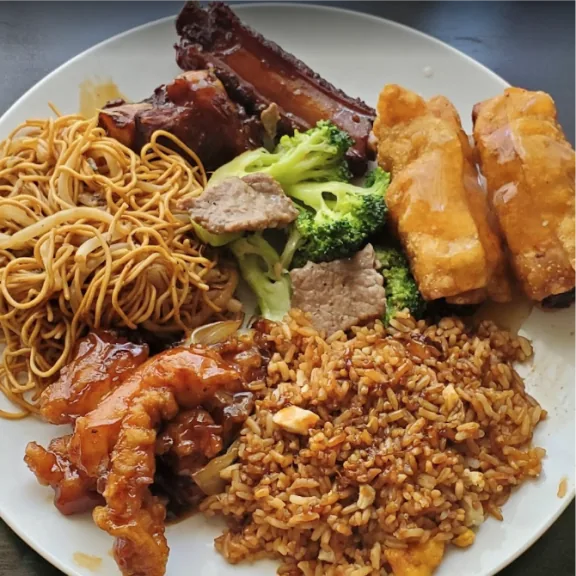 Combo plate: spare ribs, noodles, egg rolls, fried rice and chicken
